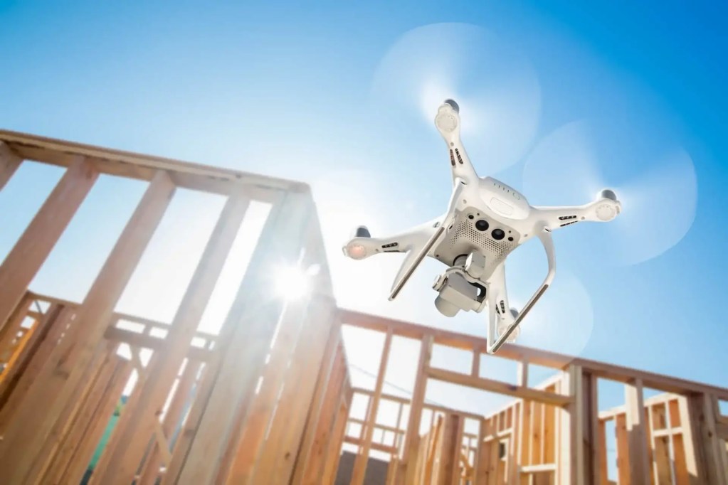 Drone taking off near construction site